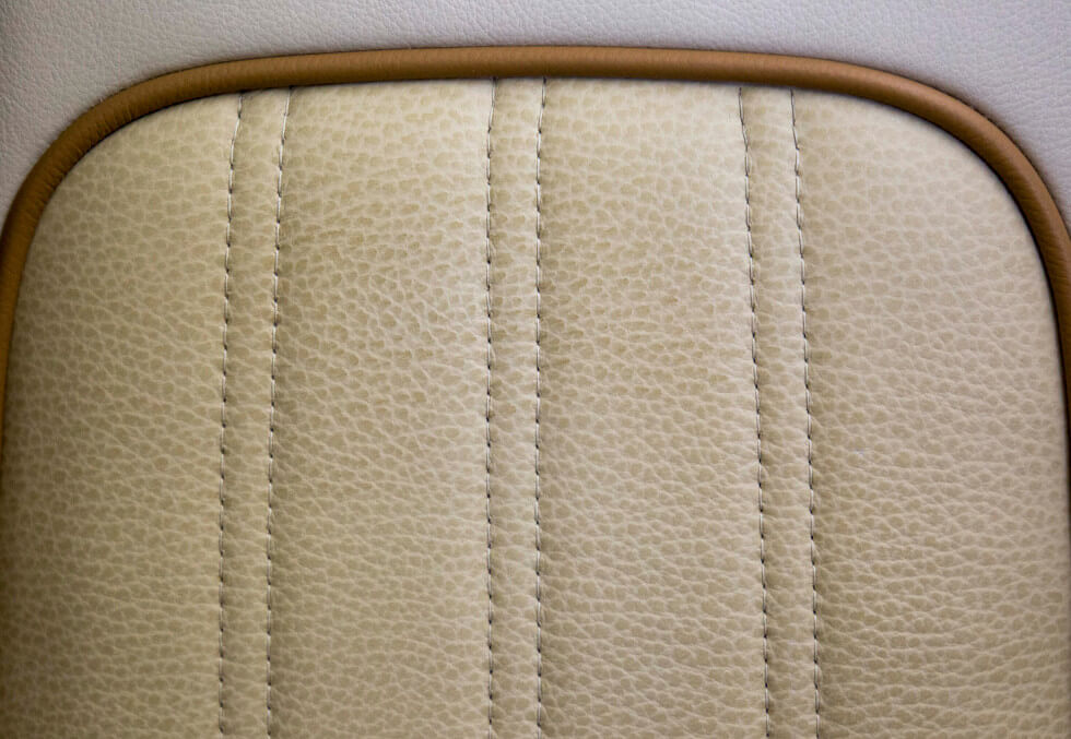 Detailed view of hand-stitched seats on a Phenom 300 aircraft interior refurbishment
